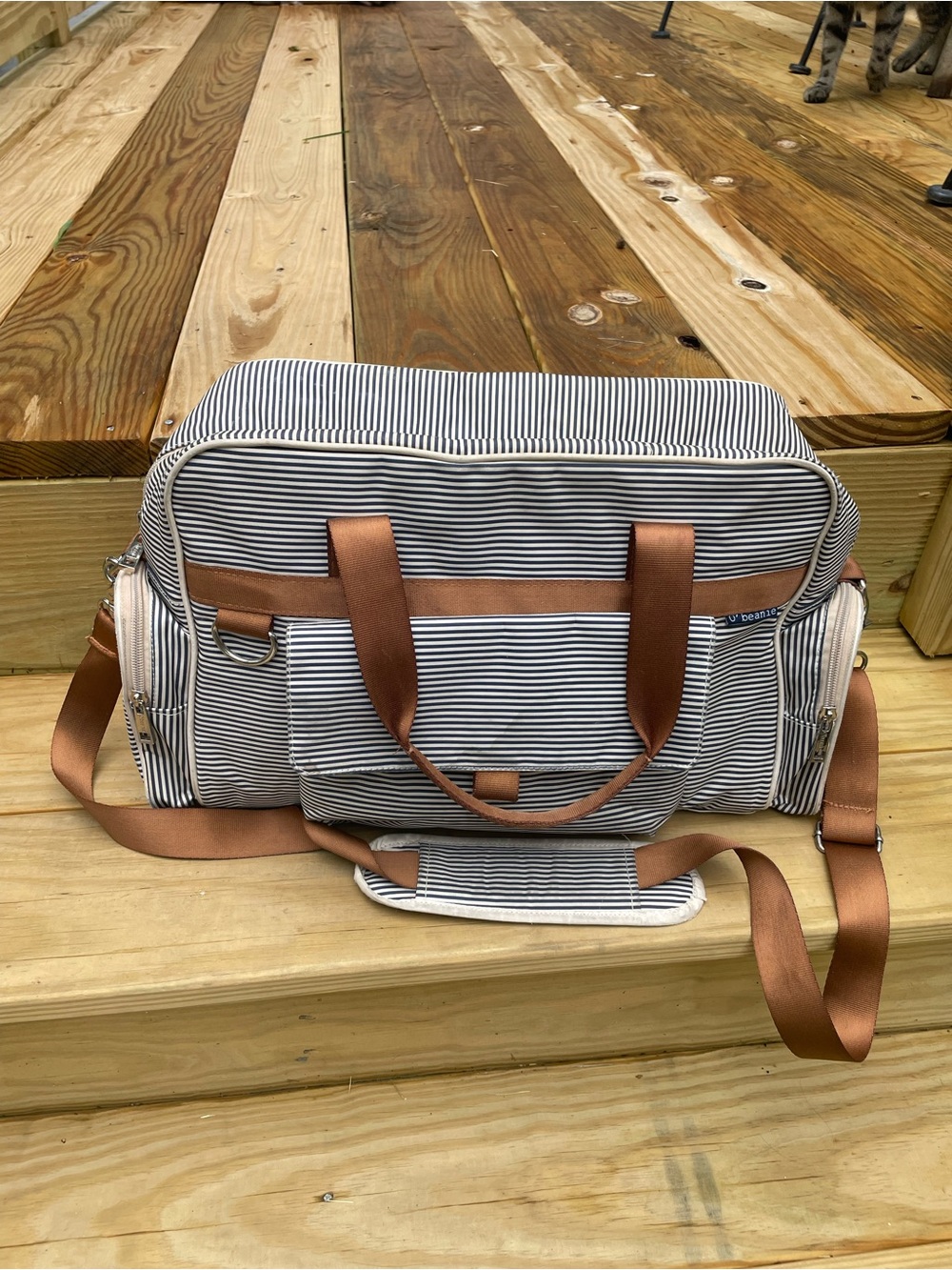 O' Beanie White and Navy Striped Diaper Bag. Brown straps with shoulder pad.